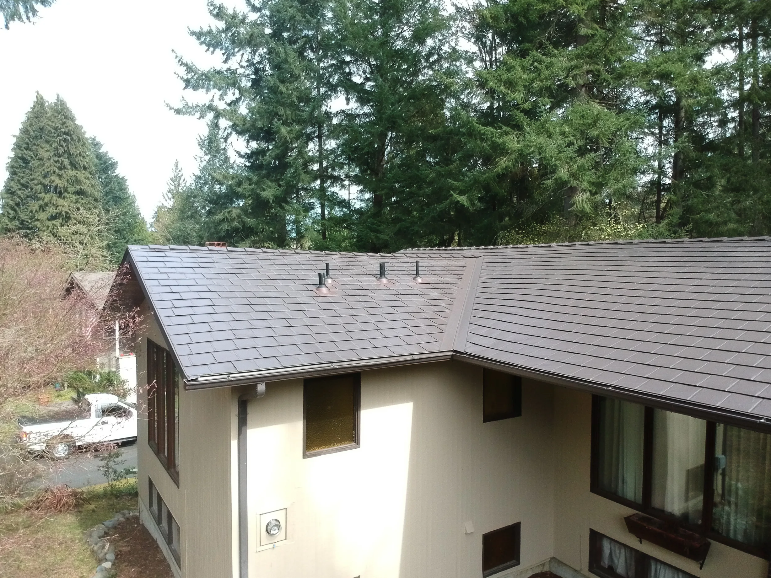 Tudor Brown Interlock Slate aluminum roof on a Tudor Brown metal roof on a two-storey ranch home in the, University Place, Washington