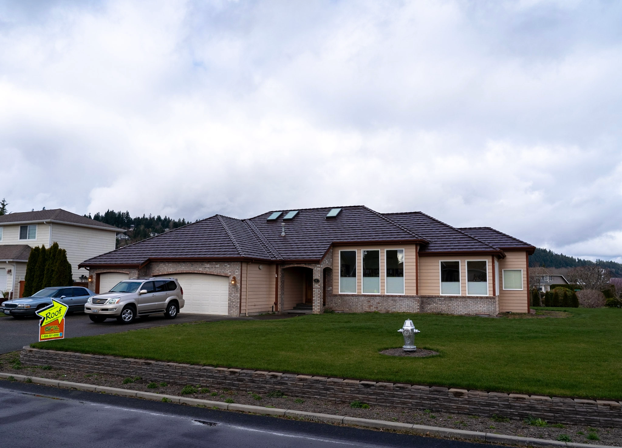 Colonial Brown Interlock Shake aluminum roof on a brown single-storey colonial home with dormers on a, Orting, Washington