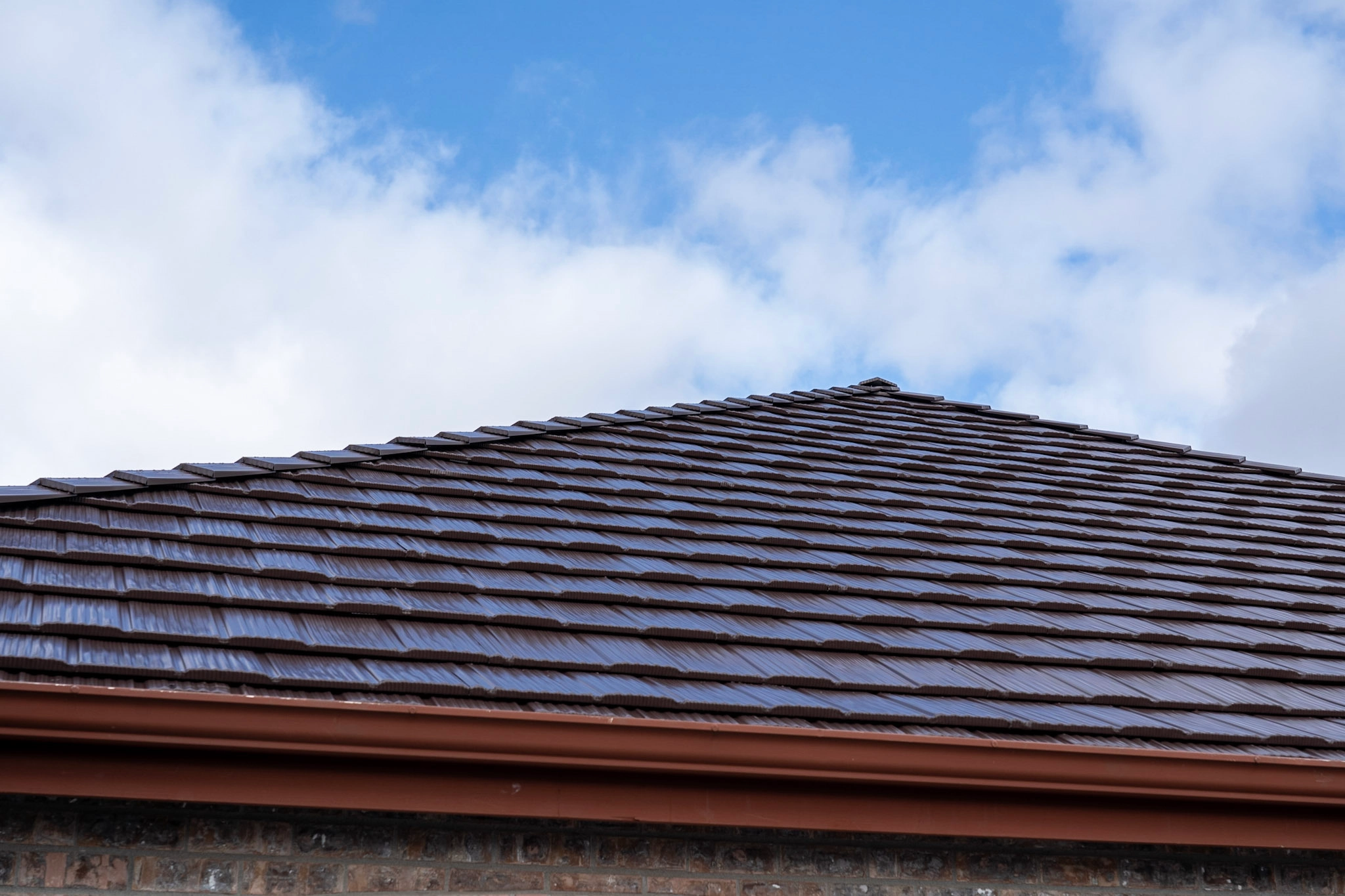 Colonial Brown Interlock Shake aluminum roof on a brown colonial home with a colonial brown metal roof in a, Orting, Washington