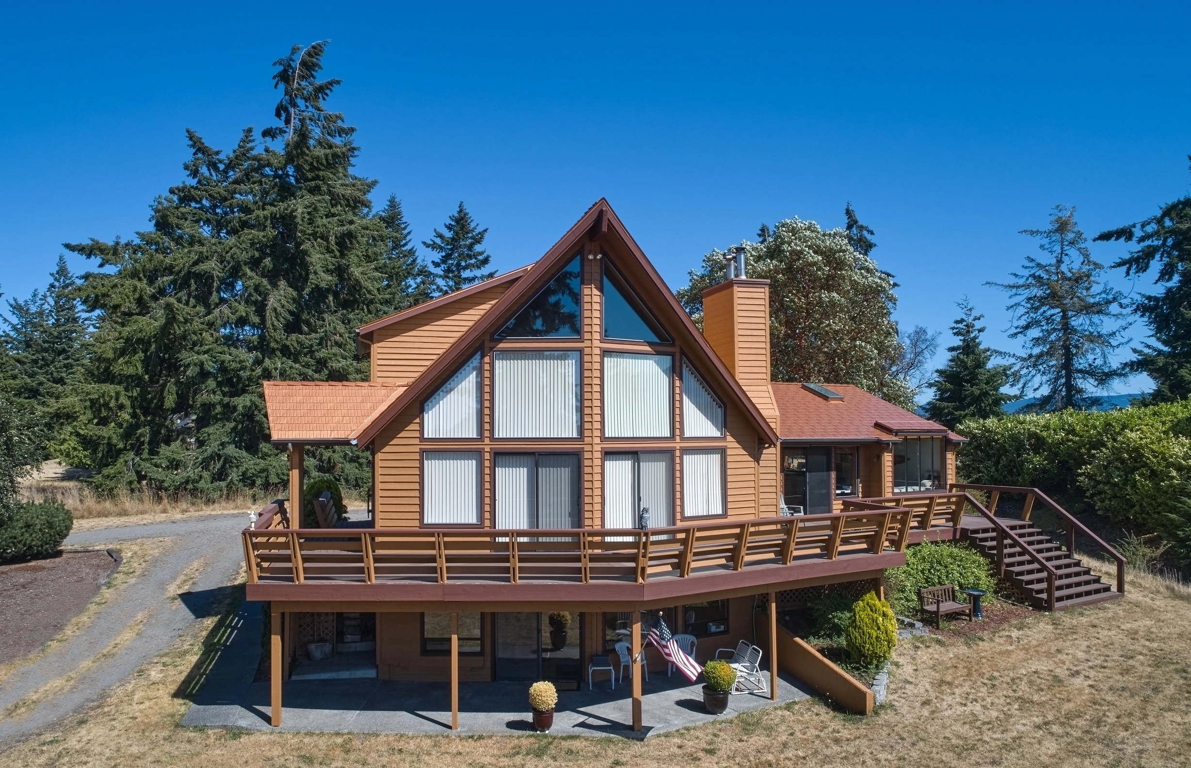 Copper Penny Interlock Cedar Shingle aluminum roof on a brown A-frame home with a copper penny metal roof in, Sequim, Washington