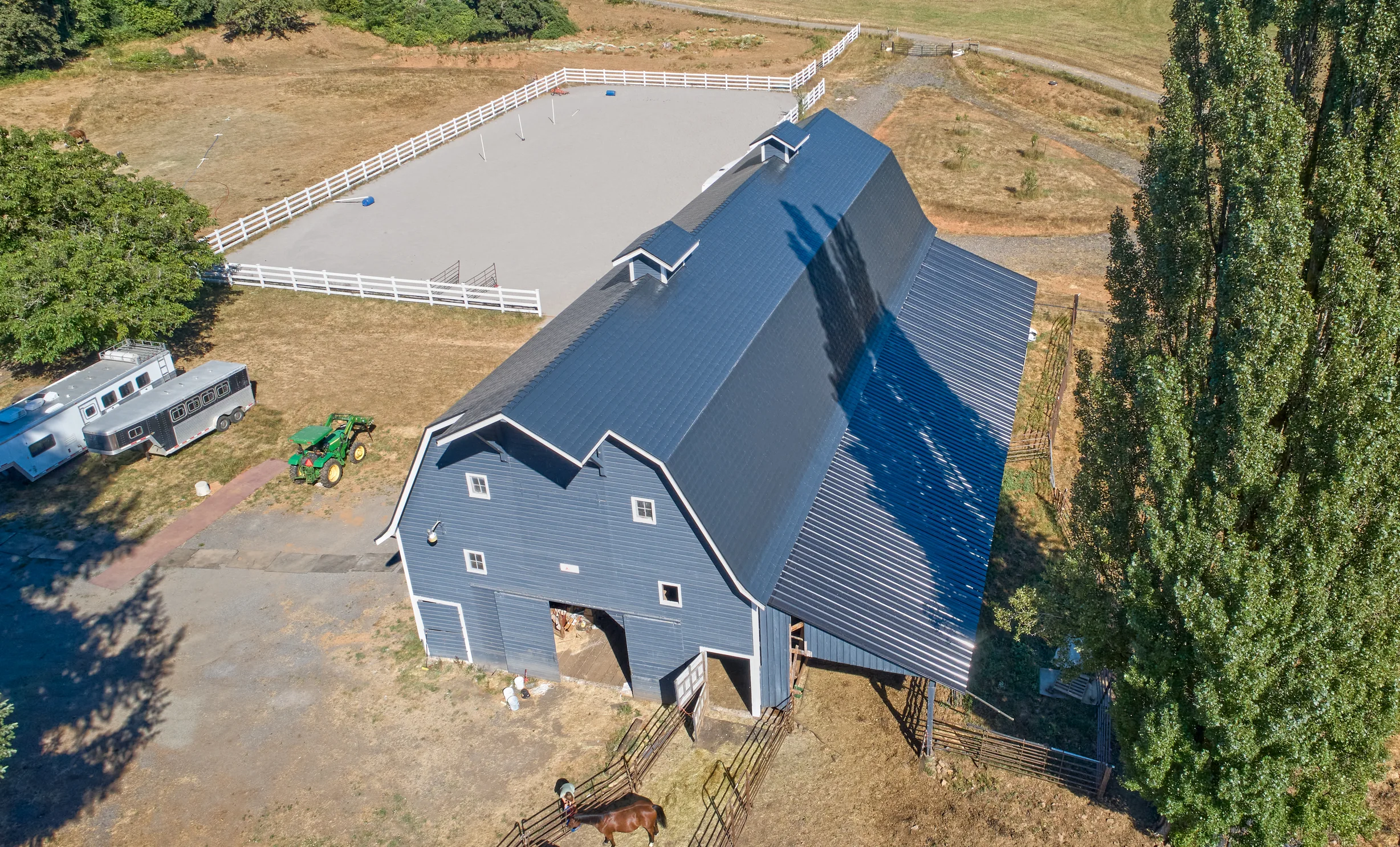 Black Interlock Slate aluminum roof on a two-storey home with a metal roof in a rural setting, Longview, Washington