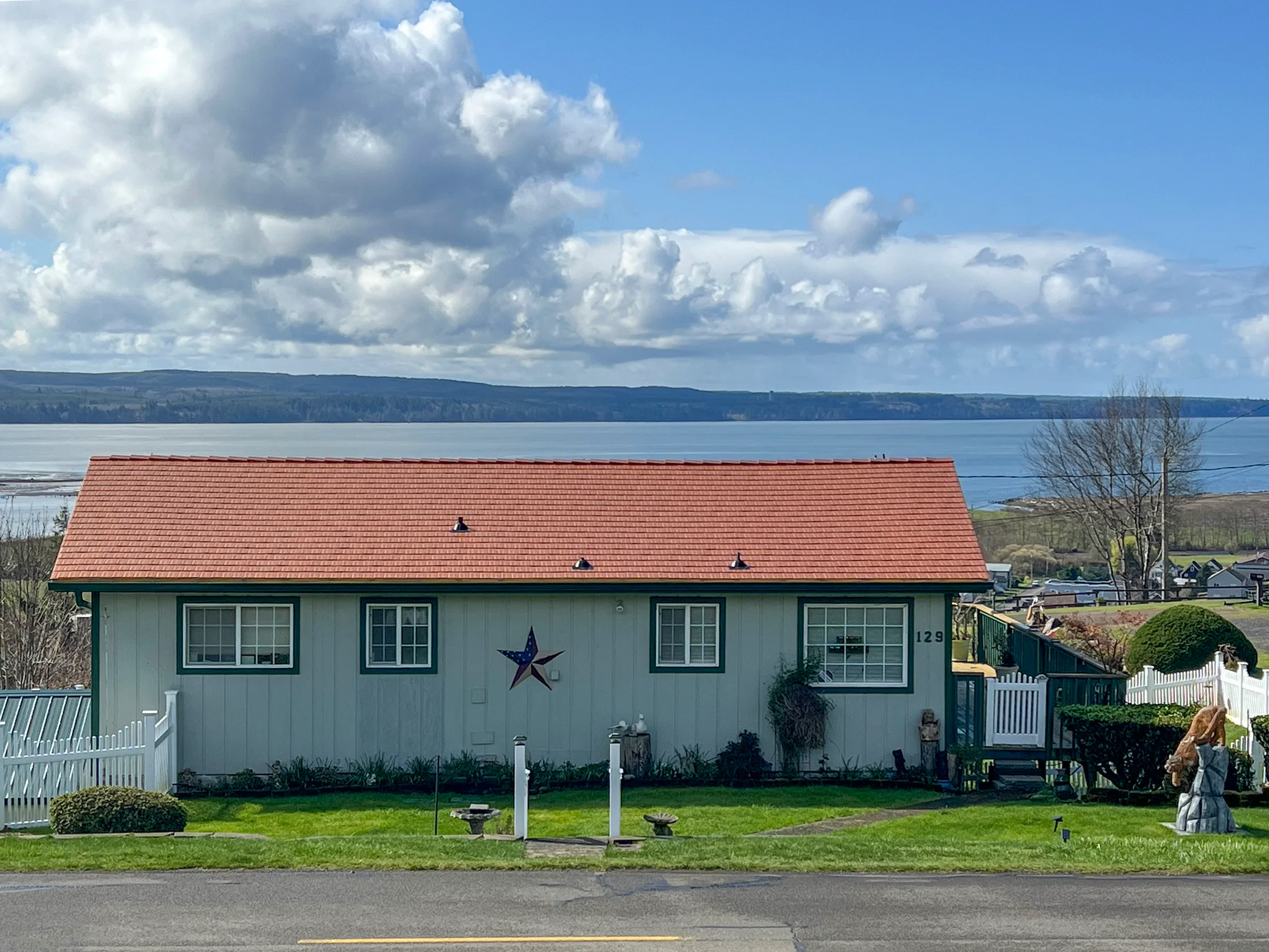 Copper Penny Interlock Cedar Shingle aluminum roof on a cottage-style home with a red metal roof on the waterfront, Hoquiam, Washington
