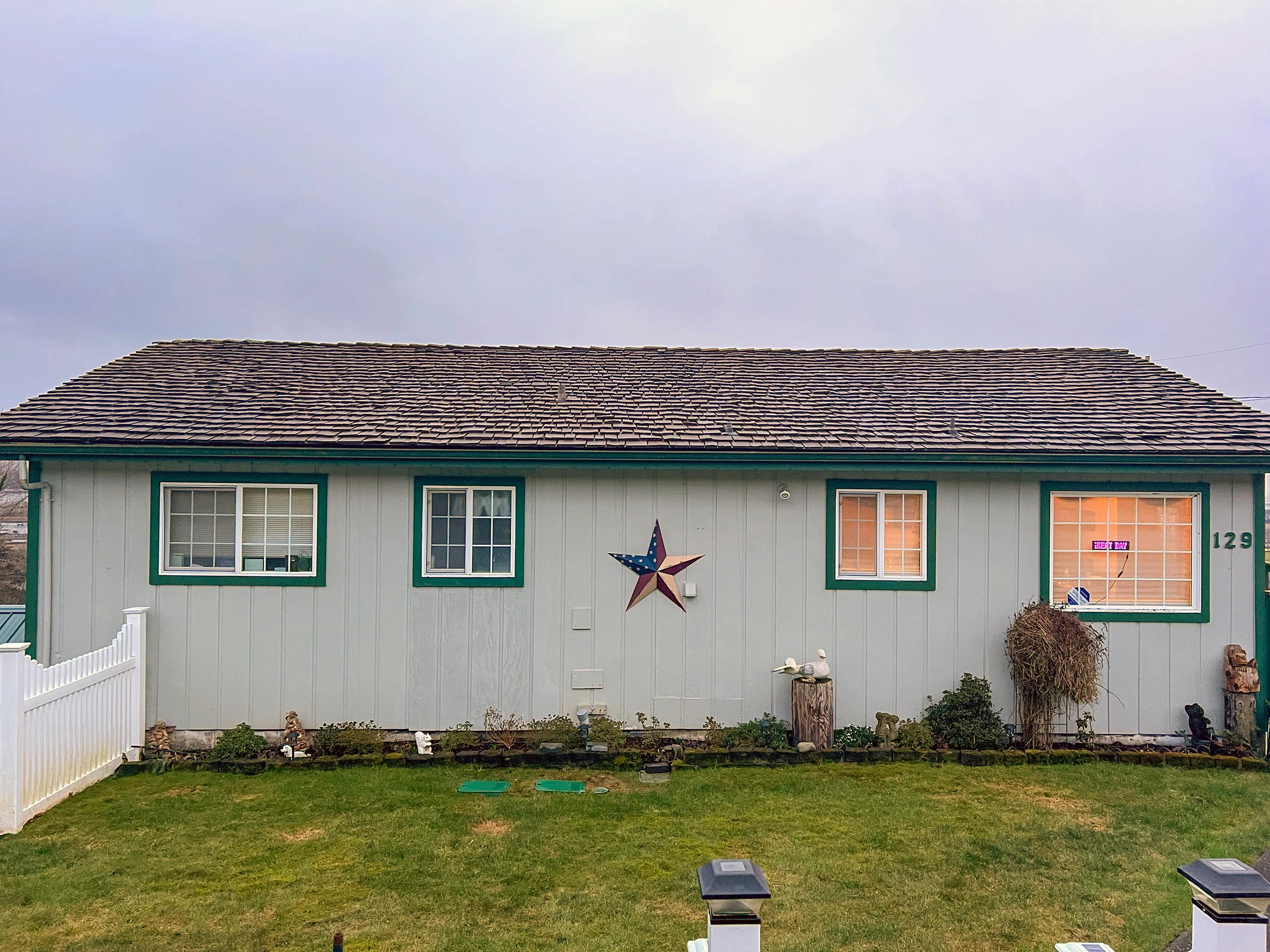 Before: a wind damaged wood shake roof on the home, Hoquiam, Washington, ahead of a Copper Penny Interlock Cedar Shingle aluminum roof