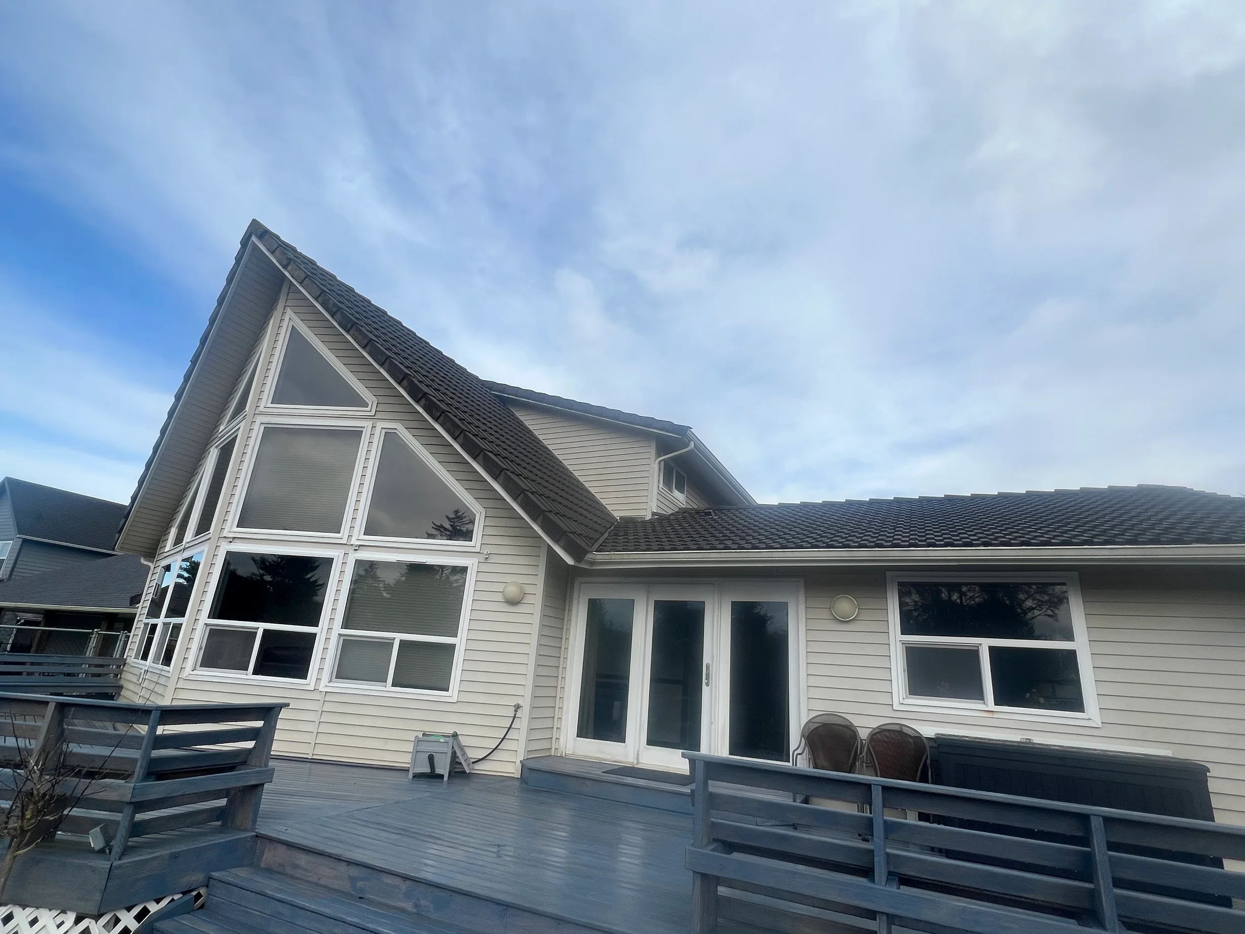 Before: the old roof on a modern single-family home with a black metal roof in, Ocean Shores, Washington, ahead of a Black Interlock Slate aluminum roof