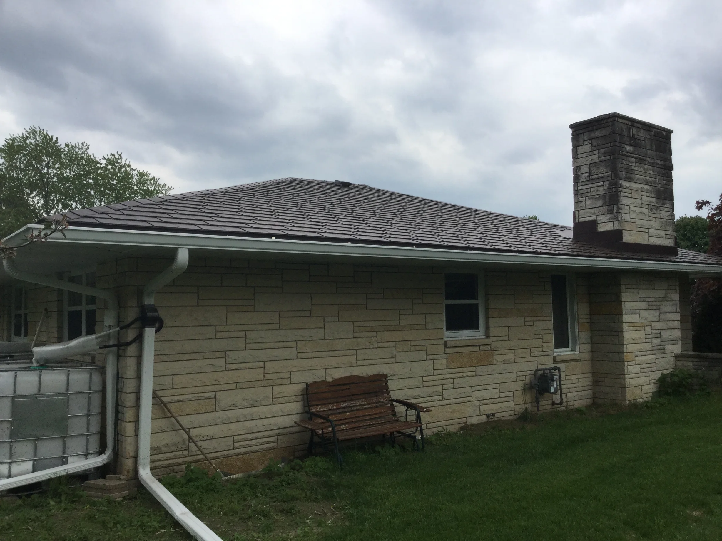 Colonial Brown Interlock Slate aluminum roof on a colonial brown metal roof on a single-story ranch home in, Kewaskum, Wisconsin