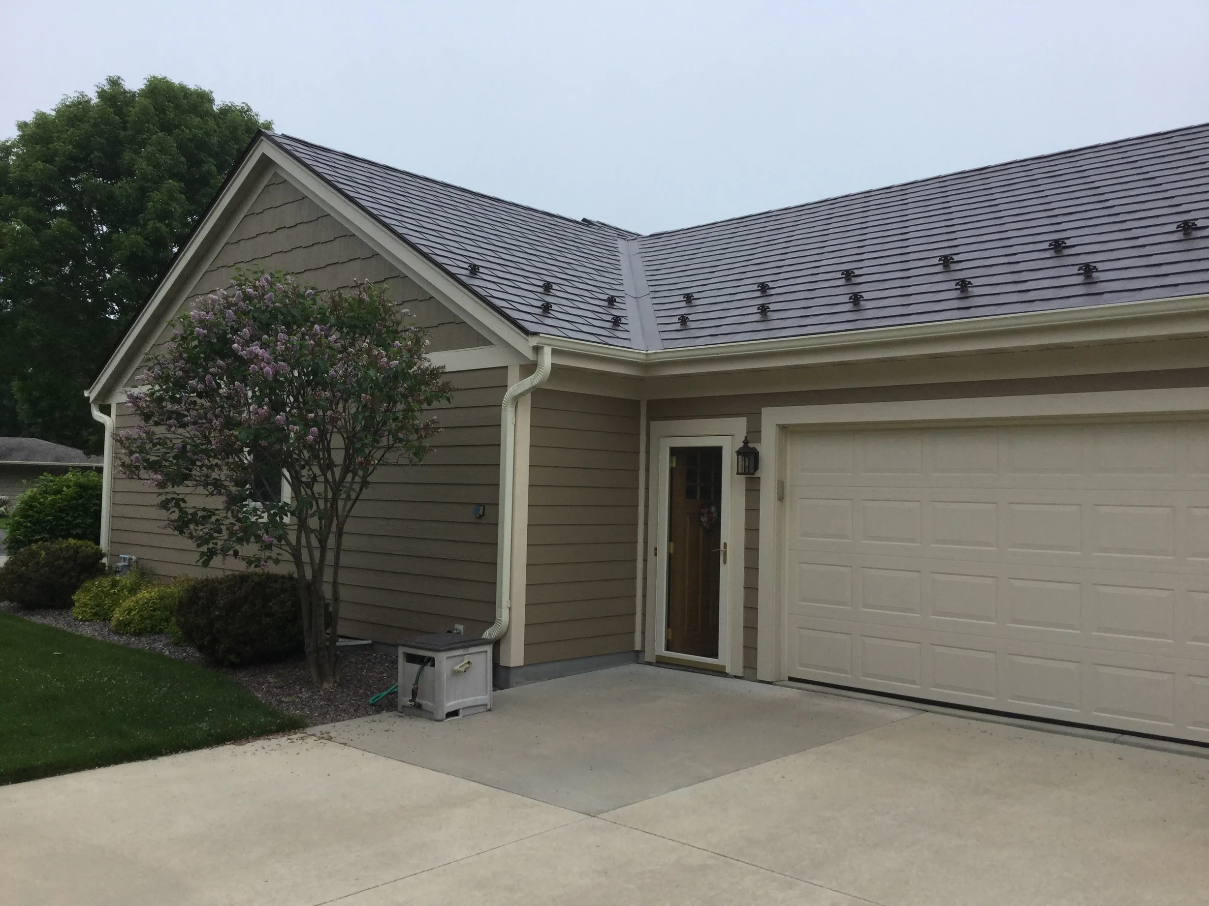 Colonial Brown Interlock Slate aluminum roof on a Colonial brown home with two storeys in a suburban setting, Port Washington, Wisconsin