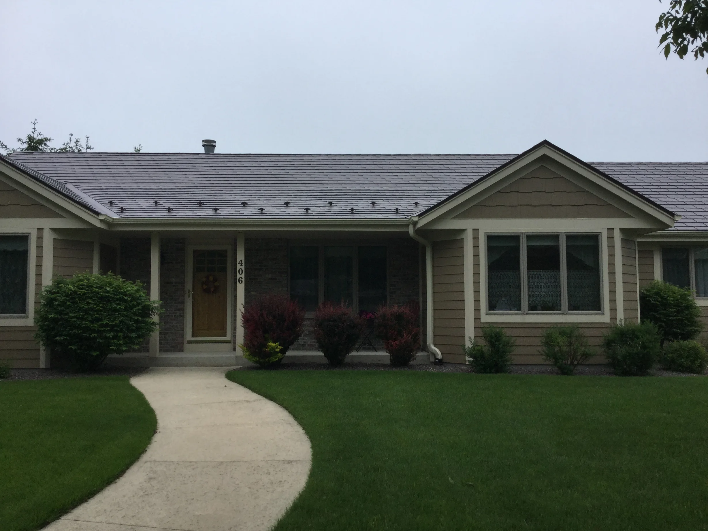 Colonial Brown Interlock Slate aluminum roof on a brown one-storey Colonial home in a rural setting, Port Washington, Wisconsin