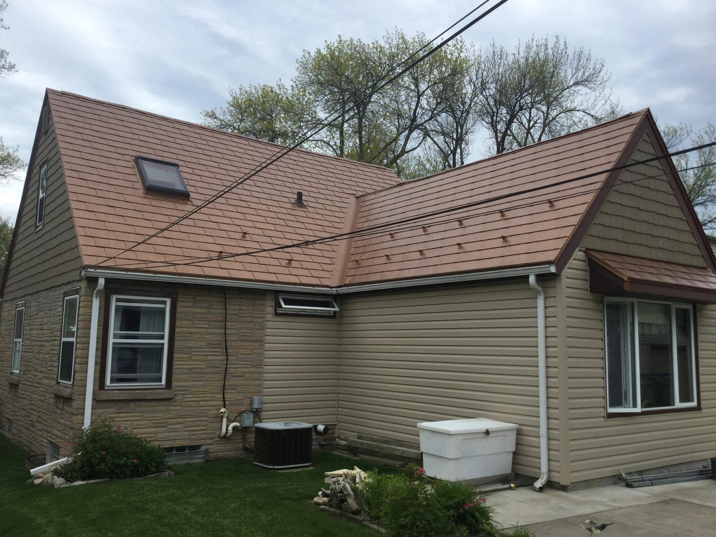 Aged Copper Interlock Slate aluminum roof on a single-family ranch home with a metal roof in a rural, Milwaukee, Wisconsin