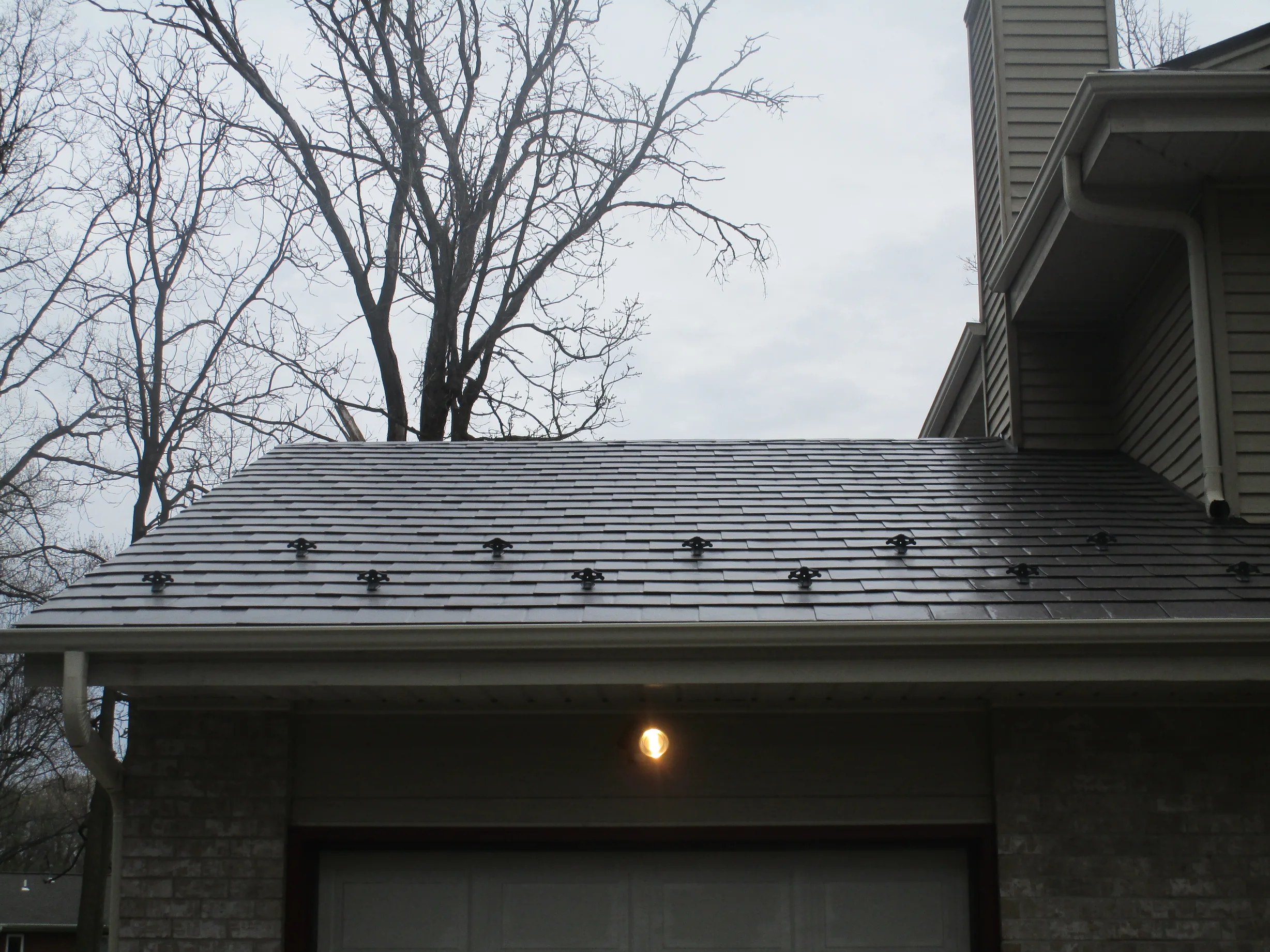 Tudor Brown Interlock Slate aluminum roof on a Tudor Brown metal roof on a Colonial style home in a, Delafield, Wisconsin