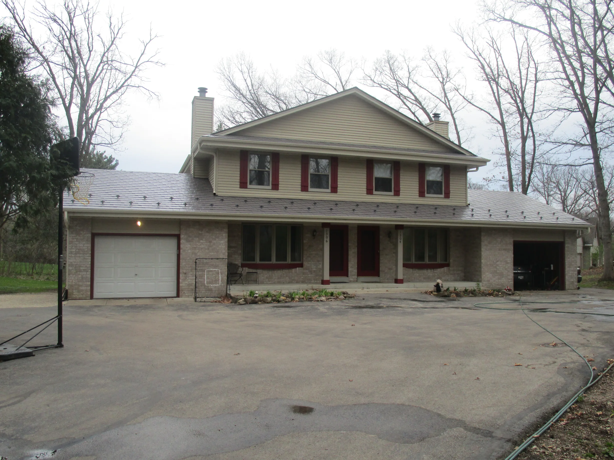 Tudor Brown Interlock Slate aluminum roof on a Tudor Brown metal roof on a two-storey colonial home in a, Delafield, Wisconsin