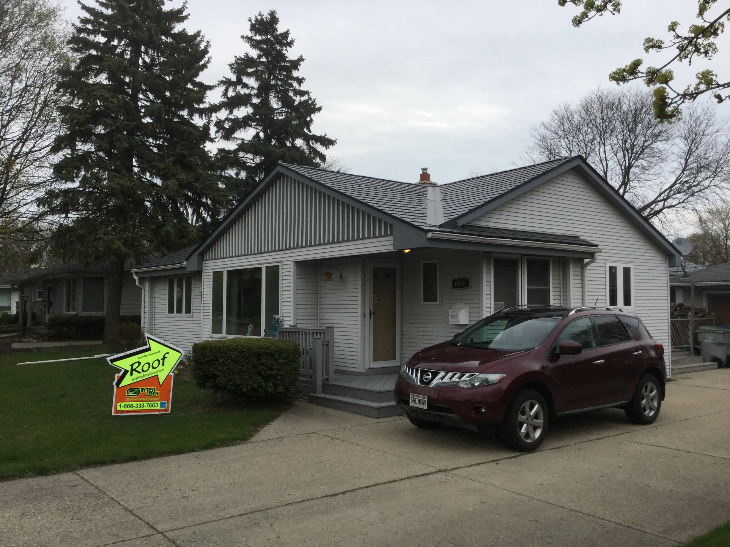 Deep Charcoal Interlock Slate aluminum roof on a white single-family home with a metal roof in a rural, Milwaukee, Wisconsin