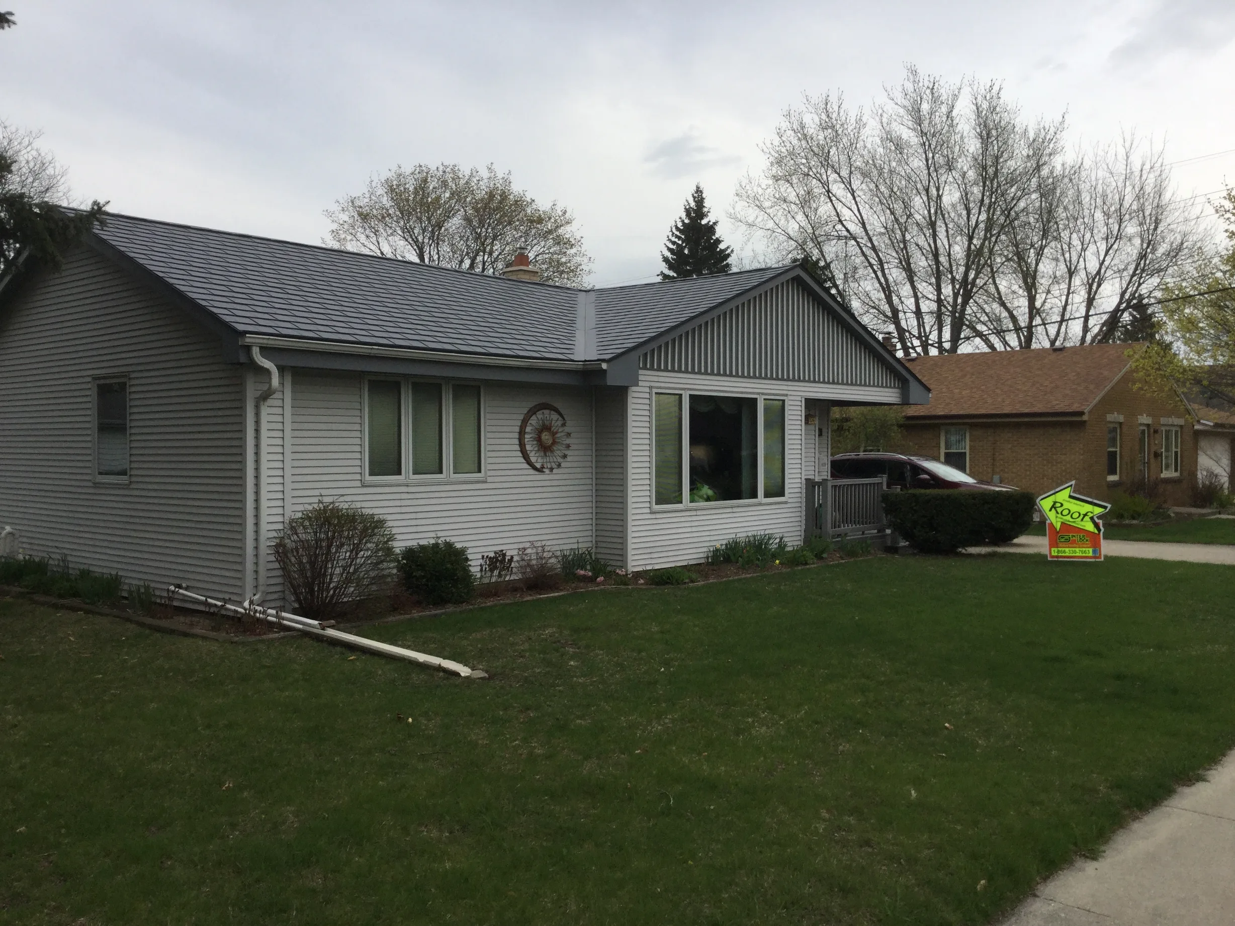 Deep Charcoal Interlock Slate aluminum roof on a Deep Charcoal Interlock Slate metal roof on a white ranch, Milwaukee, Wisconsin