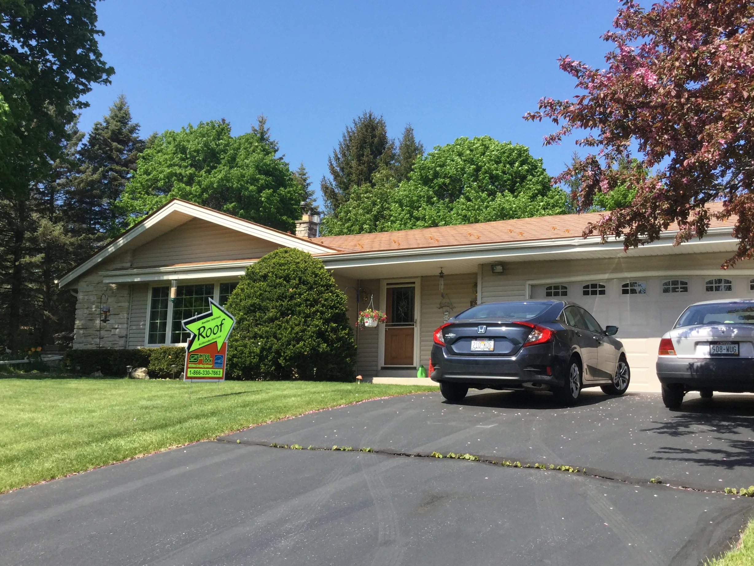 Aged Copper Interlock Slate aluminum roof on a beige ranch home with a brown door and a large tree, Colgate, Wisconsin